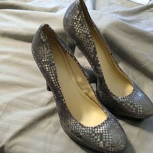 Pewter and black platform heels.